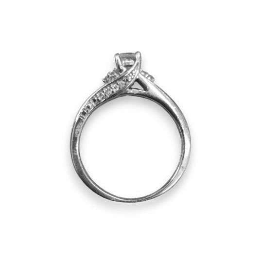9ct white gold diamond ring featuring a sparkling central diamond and elegant design, showcasing fine craftsmanship.