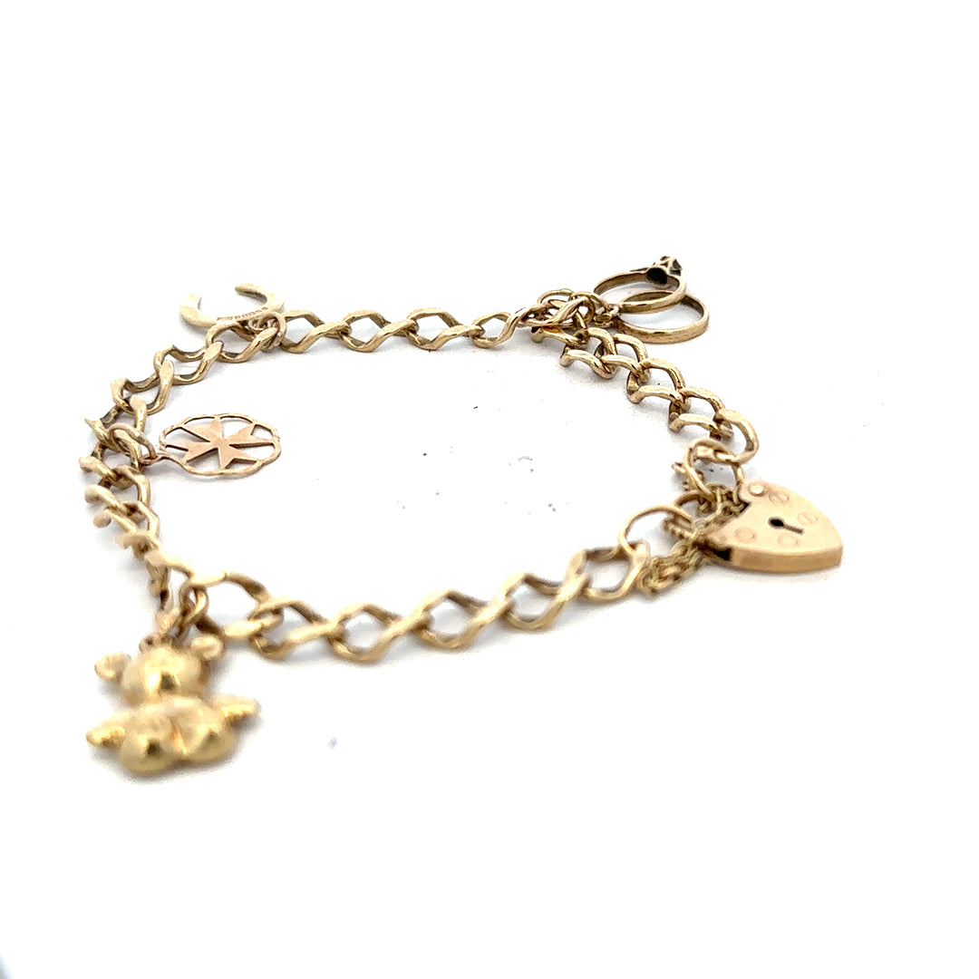9ct yellow gold charm bracelet weighing 9.9g with detailed charms and links, unbranded jewelry showcasing elegant design