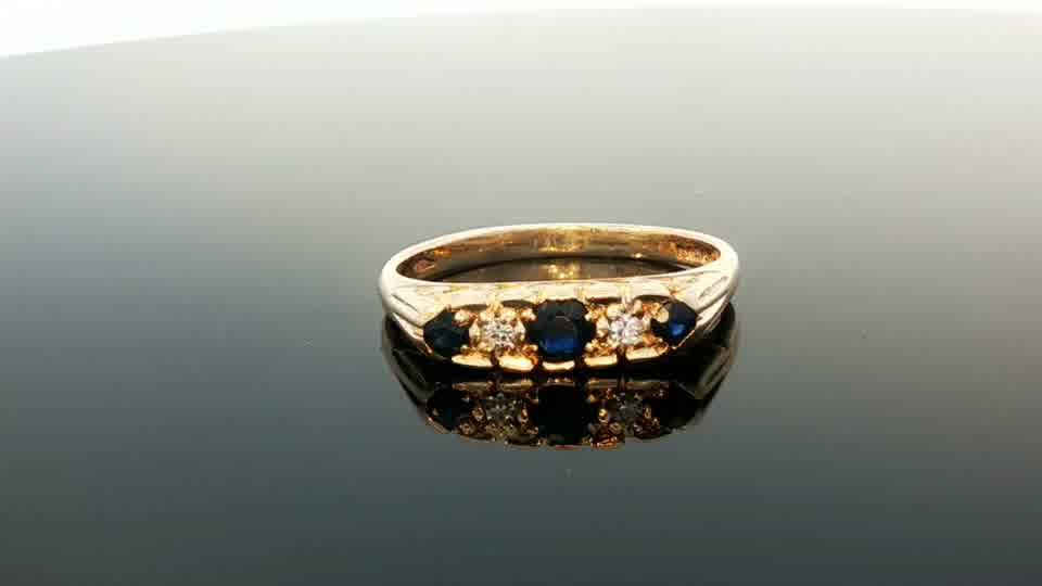 9ct yellow gold diamond and sapphire ring with intricate design, featuring sparkling diamonds and vibrant sapphires.