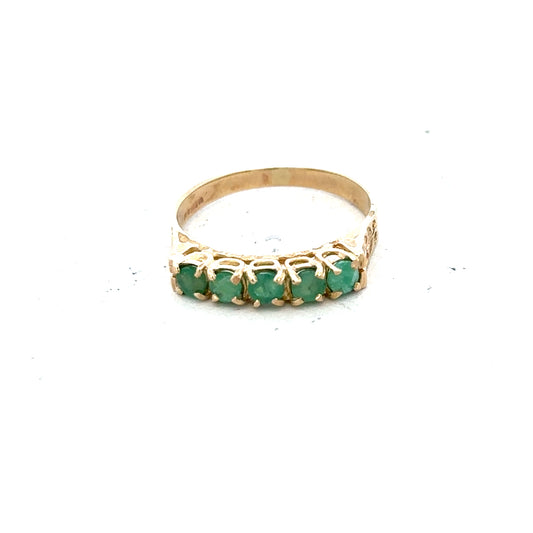 9ct yellow gold emerald ring in size P with a central emerald gemstone, displayed on a plain background.