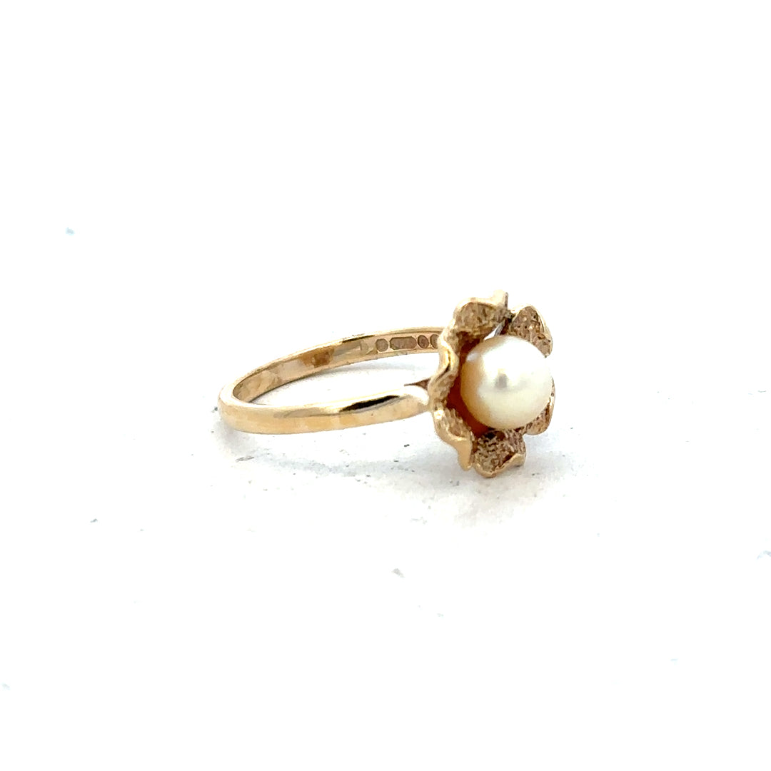 9ct yellow gold ring in size L with a simple, smooth band, unbranded, showcasing its elegant shine and craftsmanship.