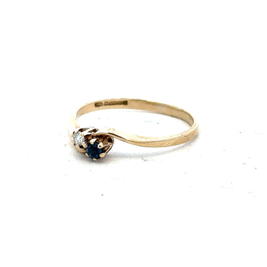 9ct yellow gold sapphire and diamond ring in size M, showcasing a detailed design with vibrant blue sapphire and sparkling diamonds.