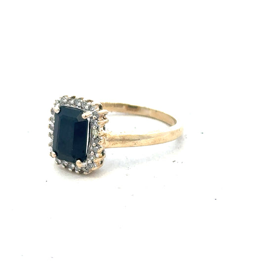 9ct yellow gold sapphire and diamond ring in size O, featuring a detailed close-up of the jewelry design.