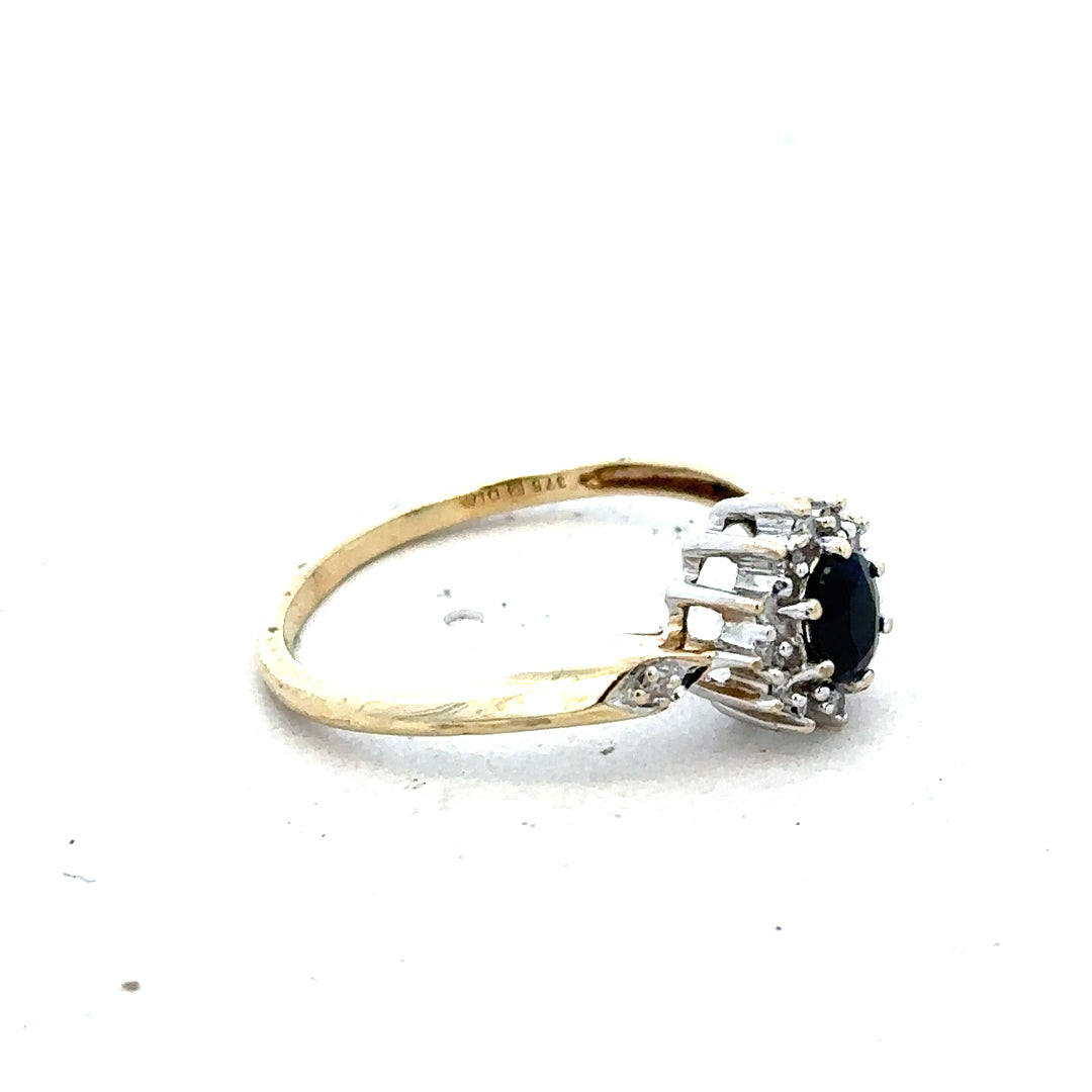 Yellow gold sapphire and diamond ring in size P, featuring a polished band with sparkling gemstones.