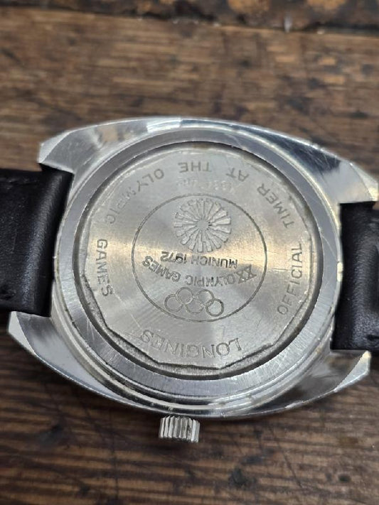 Longines 1972 Munich Olympics watch with gold-tone case and sports dial, featuring Olympic logo and chronograph functions.