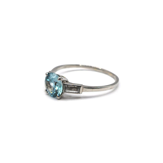Platinum topaz and cubic zirconia ring with a polished band and sparkling gemstone accents.