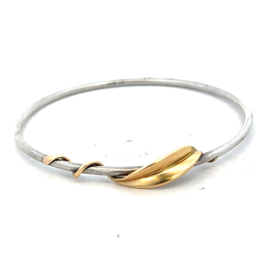 Silver bangle weighing 13.3g, showcased on a neutral background, highlighting its sleek, polished design and elegant craftsmanship.