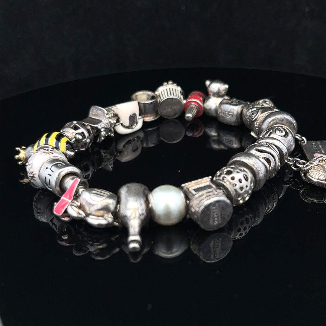 Silver charm bracelet with multiple decorative charms, featuring a 64.8 cm length, unbranded jewelry accessory.