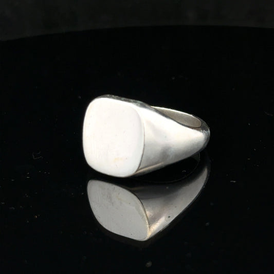 Silver signet ring in size V with a smooth, polished surface, featuring a classic design and unbranded finish.