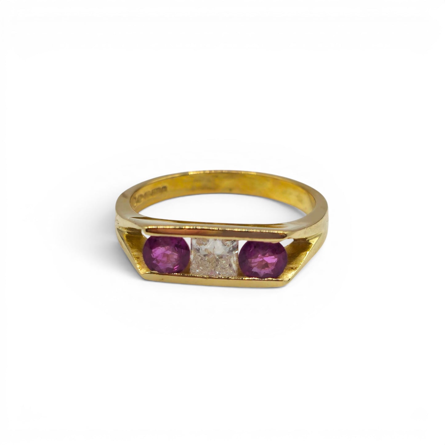 18ct yellow gold ruby and diamond ring by Reeves and Sons, featuring a central ruby gemstone and sparkling diamond accents.