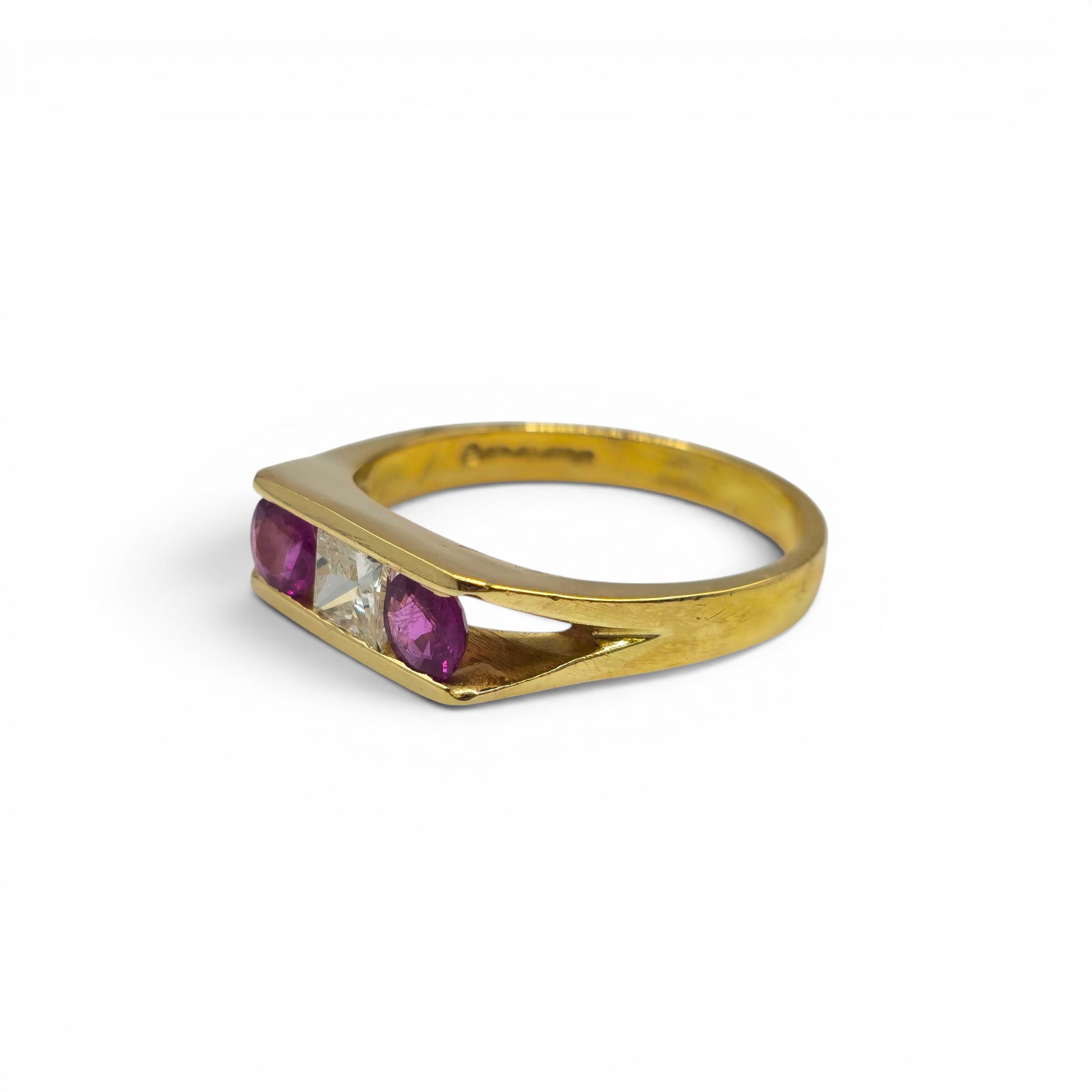 18ct yellow gold ruby and diamond ring by Reeves and Sons, featuring a central ruby gemstone and sparkling diamonds.