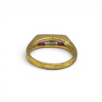 18ct yellow gold ruby and diamond ring by Reeves and Sons, featuring a central ruby surrounded by sparkling diamonds.