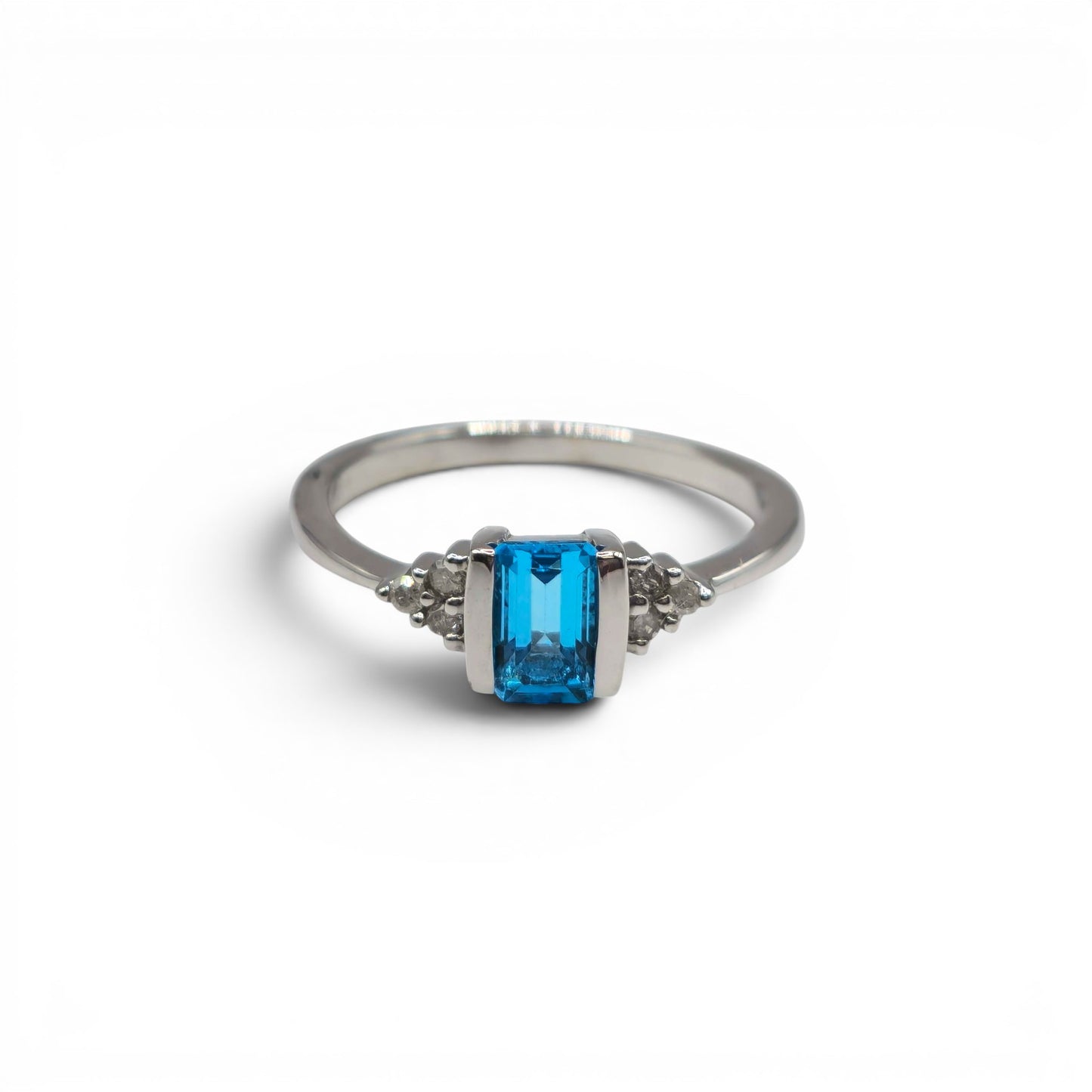 9ct white gold ring with topaz and diamond accents, crafted by Reeves and Sons, featuring a sparkling gemstone design.