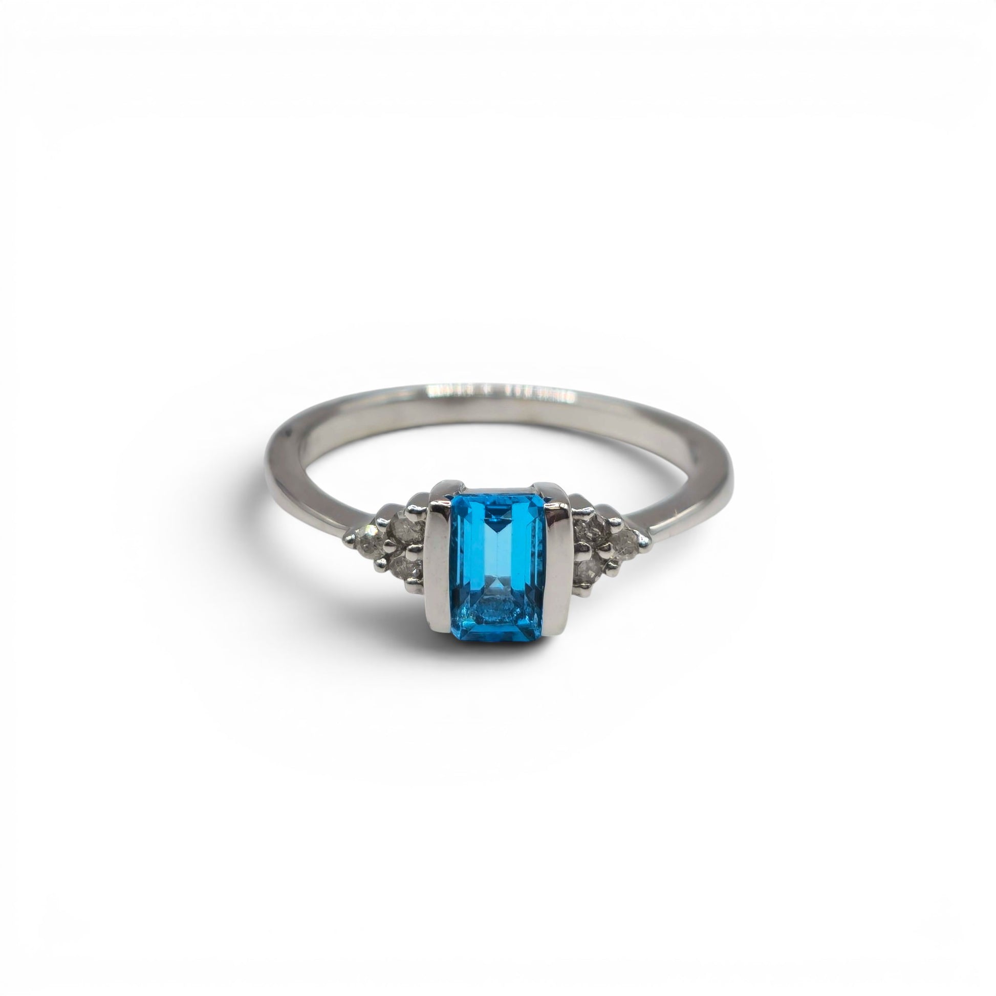9ct white gold ring with topaz and diamond accents, crafted by Reeves and Sons, featuring a sparkling gemstone design.