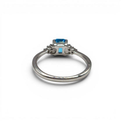 9ct white gold ring with blue topaz and diamond accents, Reeves and Sons jewelry, elegant gemstone and precious metal design