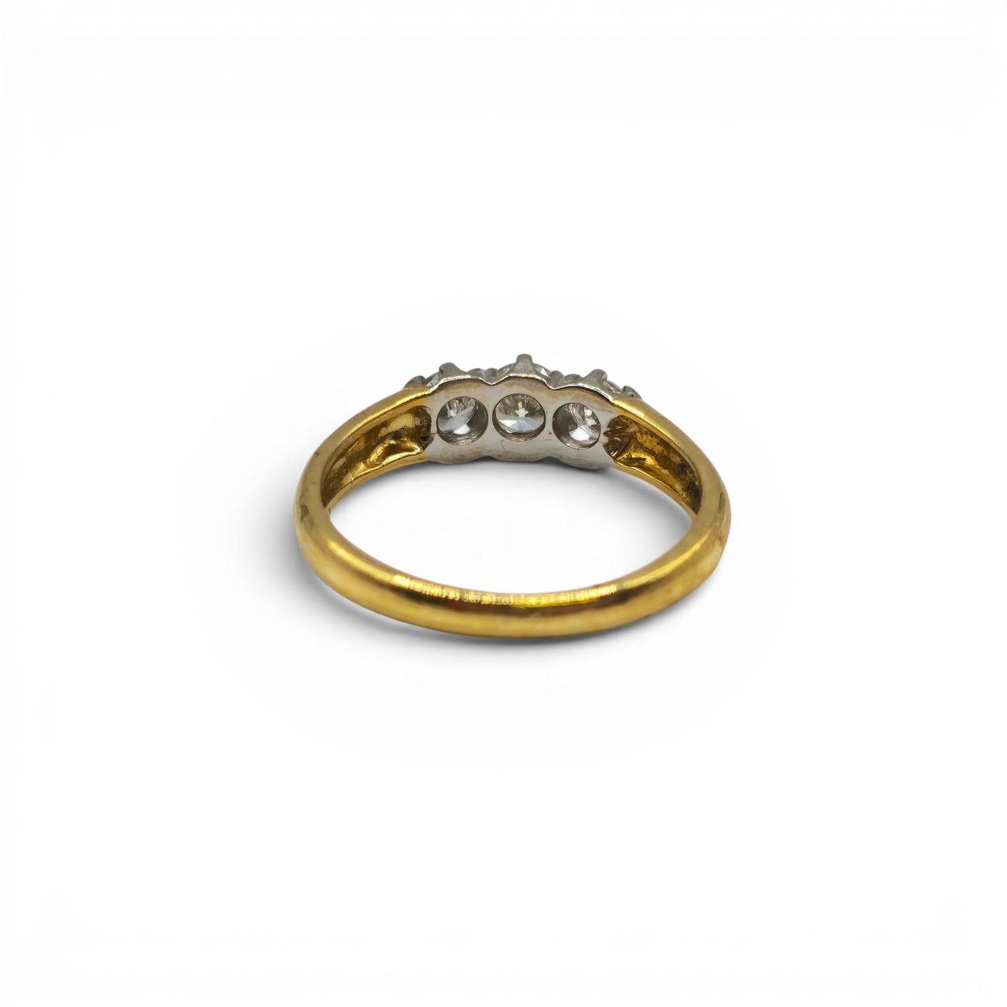 18ct yellow gold three-stone diamond ring by Reeves and Sons, featuring sparkling diamonds set in a classic design.