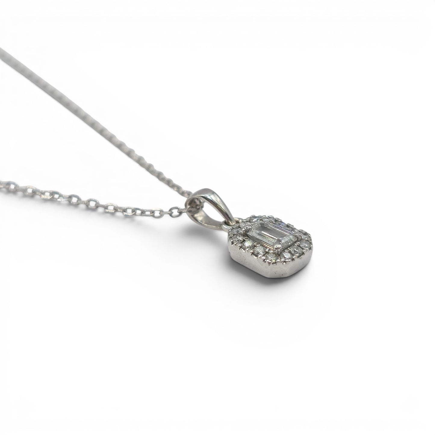 18ct white gold diamond cluster pendant with sparkling diamonds, crafted by Reeves and Sons, shown on a white background.