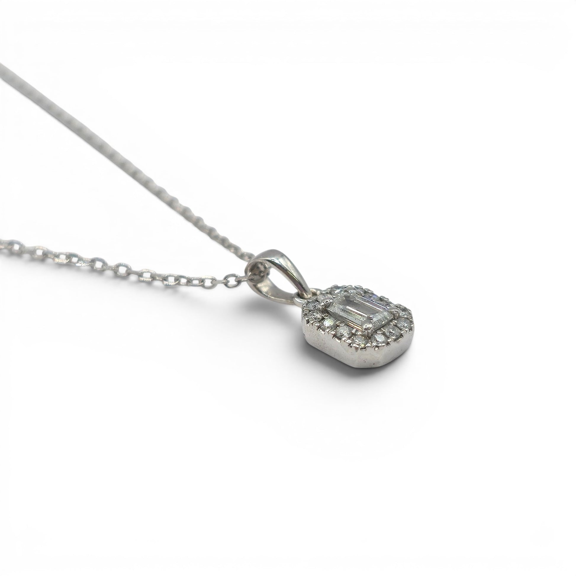 18ct white gold diamond cluster pendant with sparkling diamonds, crafted by Reeves and Sons, shown on a white background.