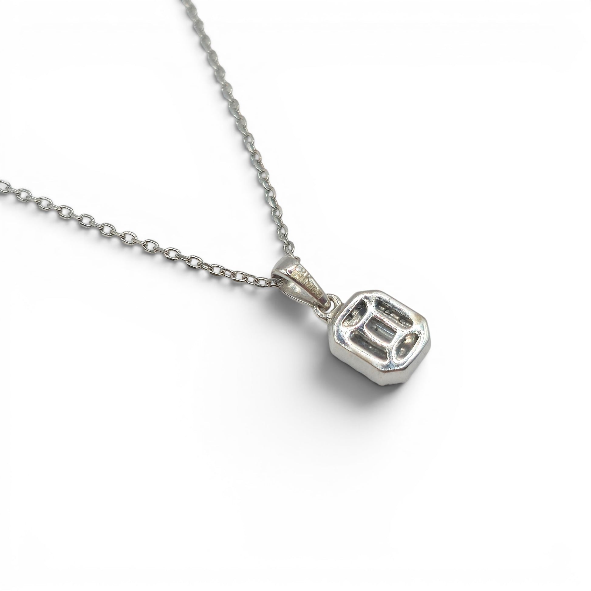 18ct white gold diamond cluster pendant by Reeves and Sons, featuring sparkling diamonds set in a elegant design.