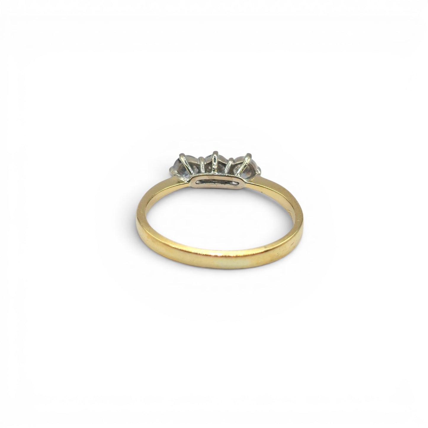 18ct yellow gold three-stone diamond ring by Reeves and Sons, featuring a central diamond with two side stones on a polished band.