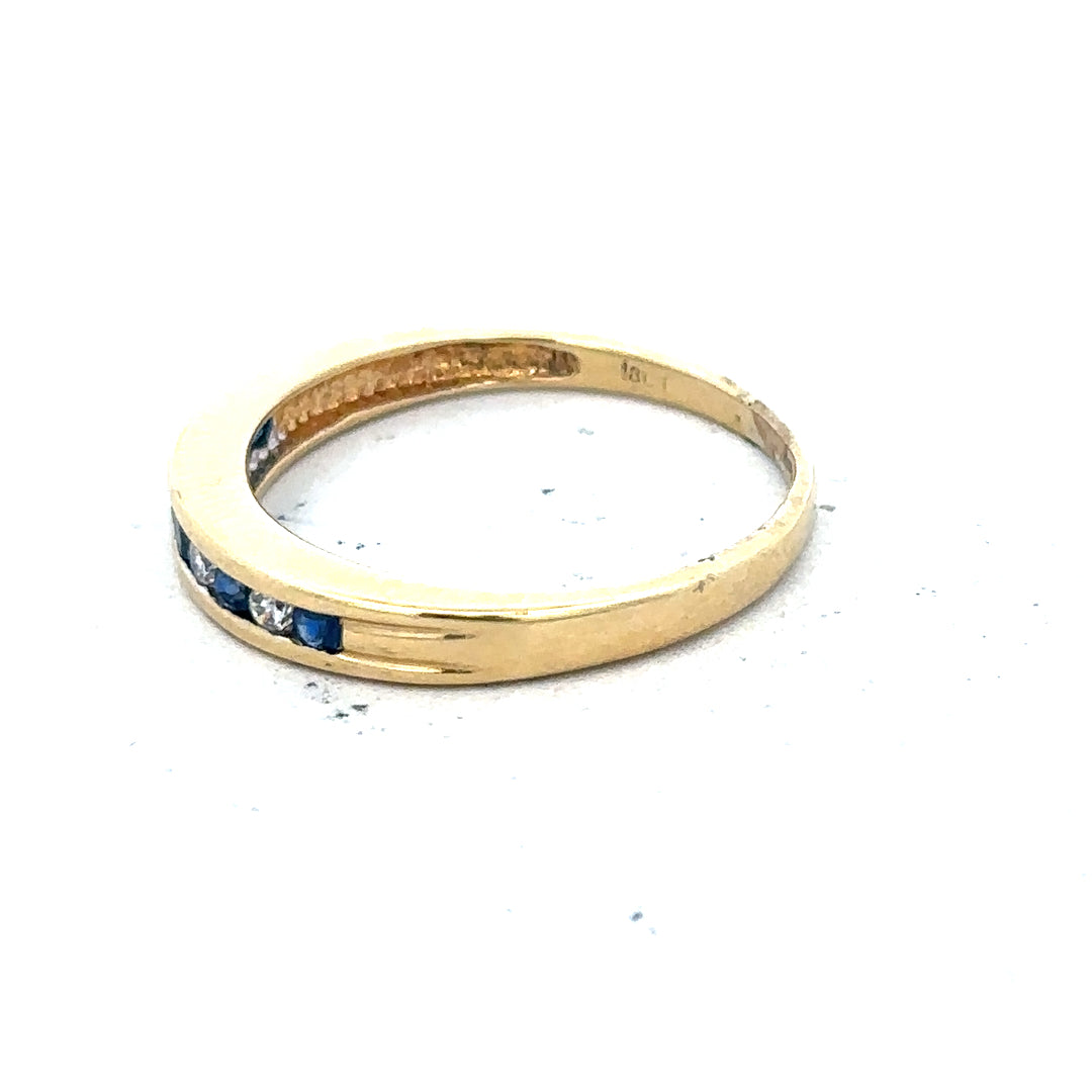 18ct yellow gold sapphire and diamond ring, size S, featuring a polished band with a central sapphire and sparkling diamonds.