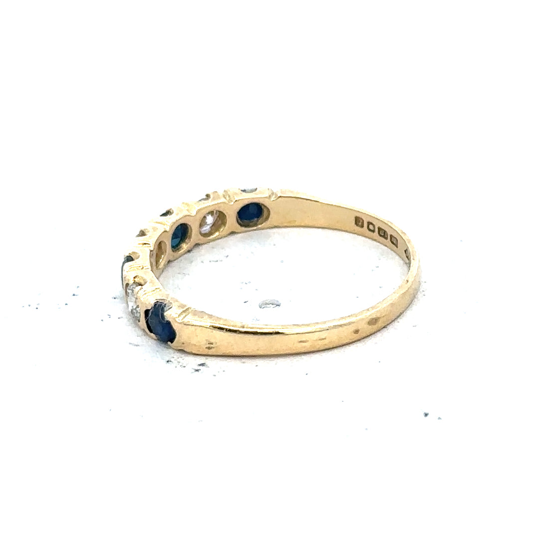 18ct yellow gold diamond and sapphire ring, size M 1/2, featuring sparkling gemstones and a polished band.