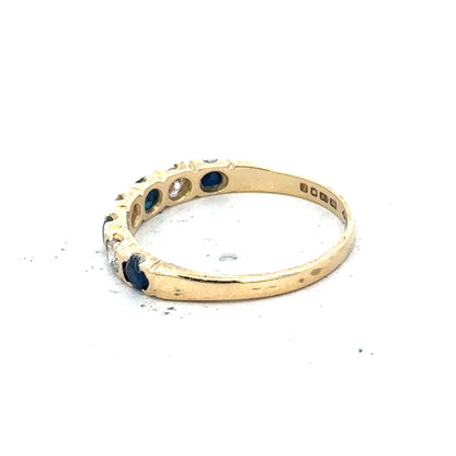 18ct yellow gold diamond and sapphire ring, size M 1/2, featuring sparkling gemstones and a polished band.