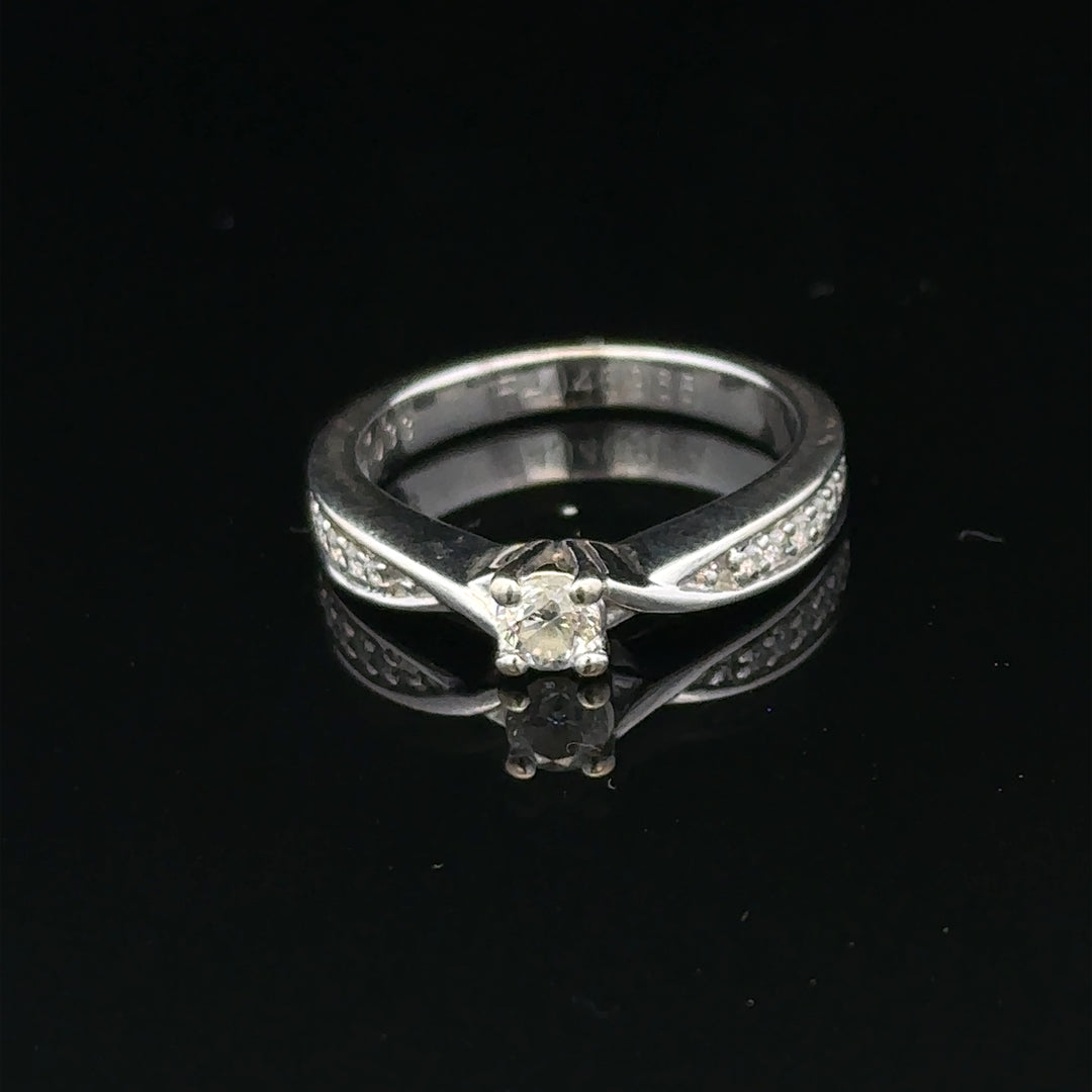 18ct white gold diamond ring with 1/3 carat round diamond, size J, featuring elegant craftsmanship and sparkling gemstone.