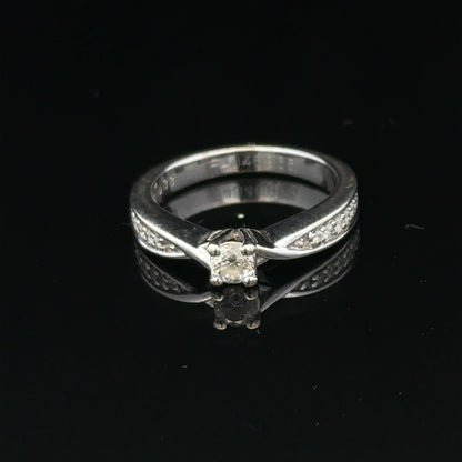 18ct white gold diamond ring with 1/3 carat round diamond, size J, featuring elegant craftsmanship and sparkling gemstone.