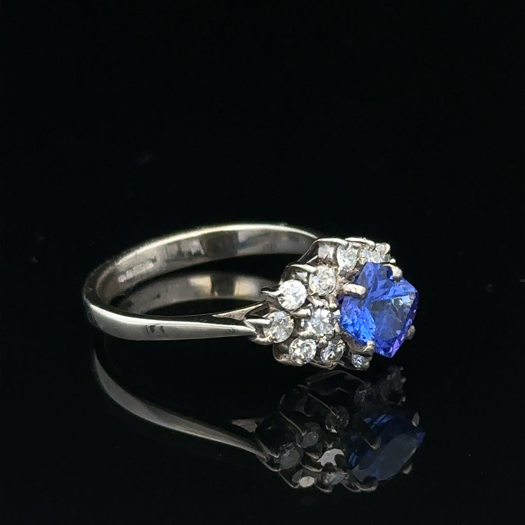 18ct white gold ring with diamonds and tanzanite gemstone, size O, featuring intricate jewelry design and sparkling stones.