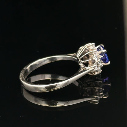 18ct white gold diamond and tanzanite ring in size O, featuring sparkling gemstones and intricate metalwork.