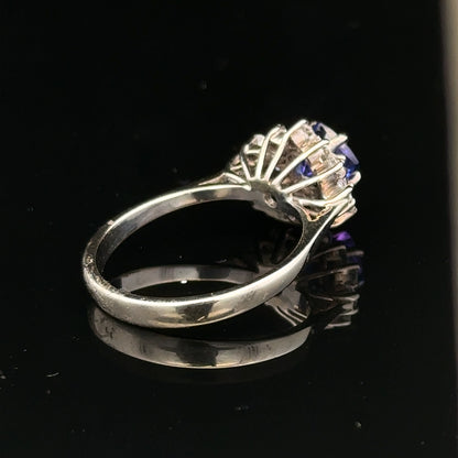 18ct white gold diamond and tanzanite ring in size O with intricate design and sparkling gemstones.