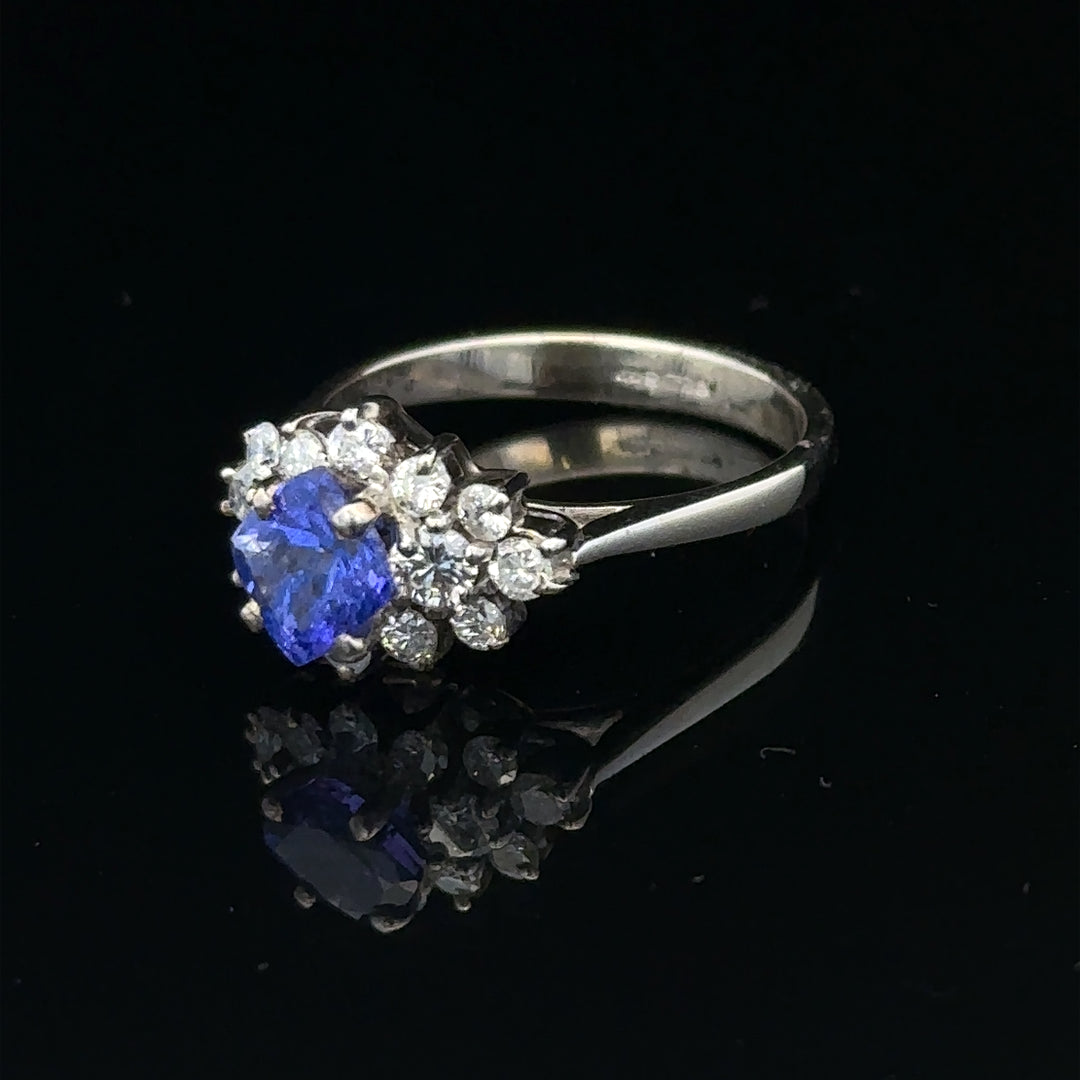 18ct white gold diamond and tanzanite ring in size O with sparkling gemstones and intricate band detail.