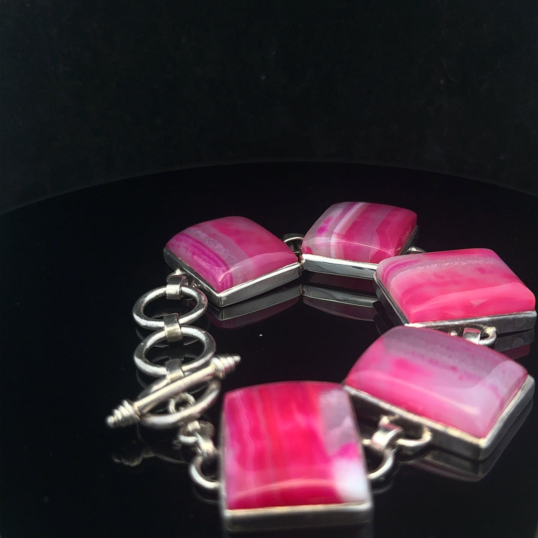 Silver gemstone bracelet featuring polished stones and elegant design, perfect for stylish accessories.