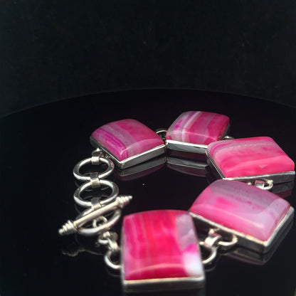 Silver gemstone bracelet featuring polished stones and elegant design, perfect for stylish accessories.