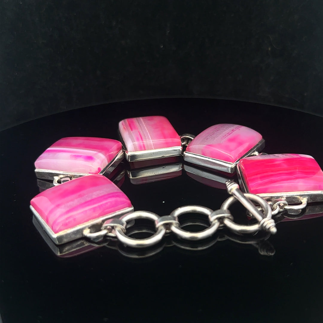 Silver gemstone bracelet featuring polished stones and intricate design, perfect for elegant jewelry collection.