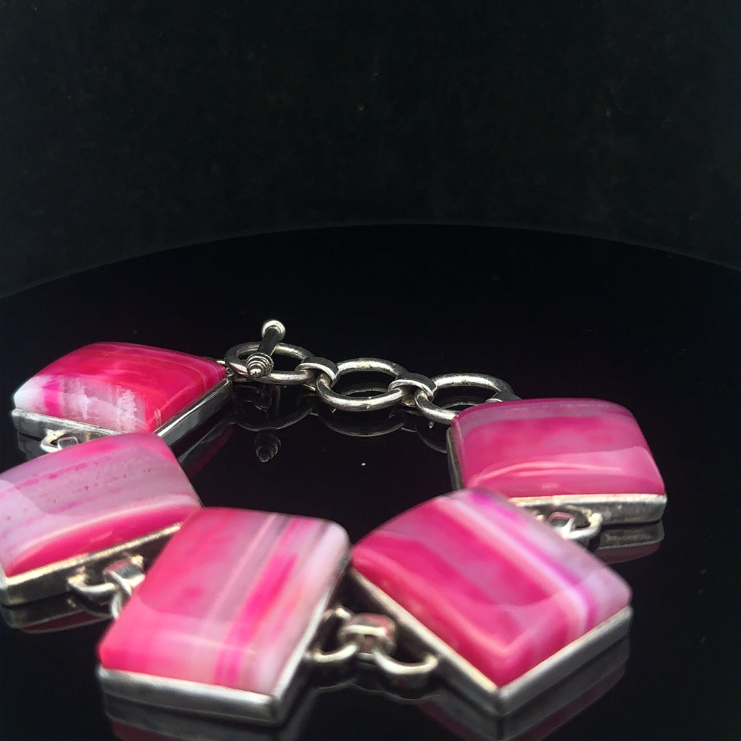 Silver gemstone bracelet featuring polished stones and intricate design, perfect for elegant jewelry styling.