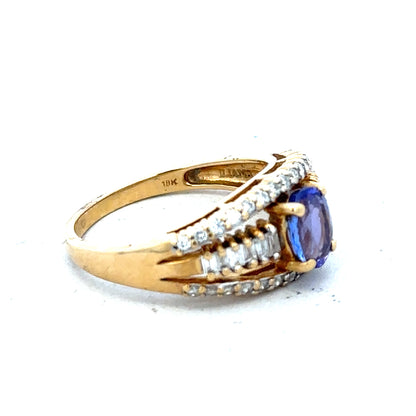 18ct yellow gold diamond and tanzanite ring in size N1/2, featuring a sparkling tanzanite gemstone and intricate gold setting.