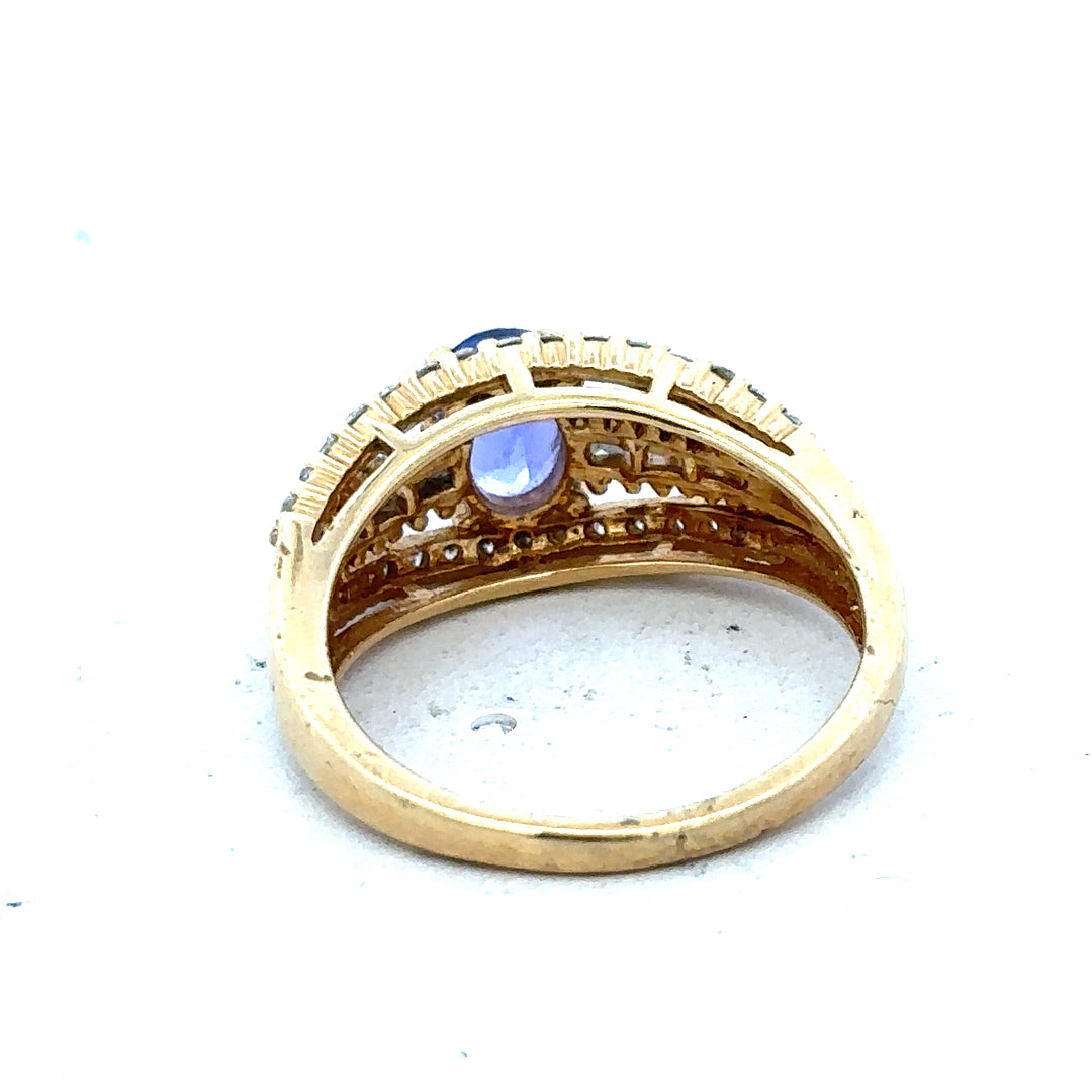 18ct yellow gold diamond and tanzanite ring in size N1/2, featuring a vibrant gemstone and elegant gold setting.