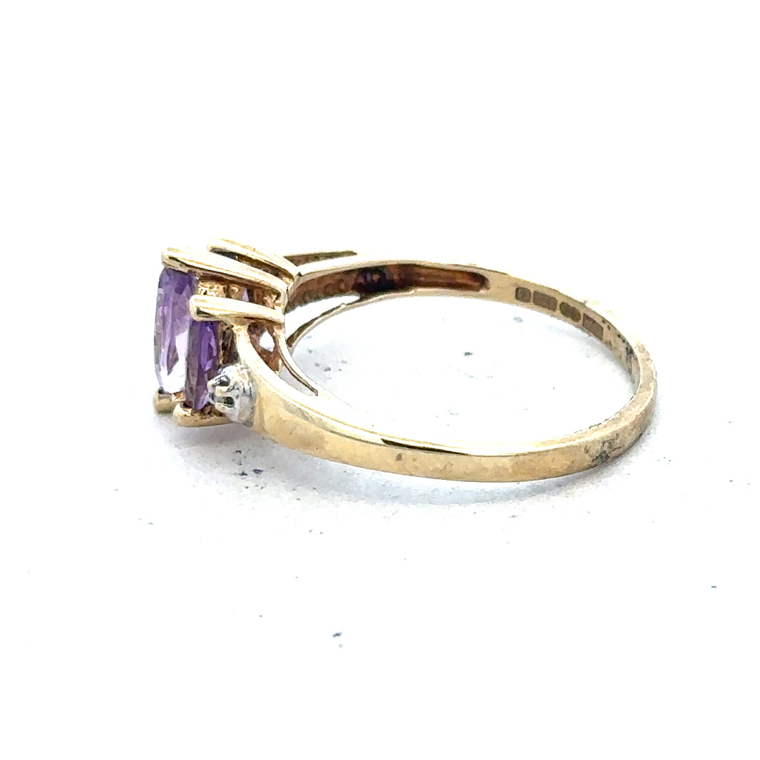 9ct yellow gold amethyst and diamond ring, size P, featuring a central purple amethyst gemstone with diamond accents.