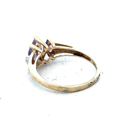 9ct yellow gold amethyst and diamond ring in size P, featuring a central purple gemstone surrounded by small sparkling diamonds.
