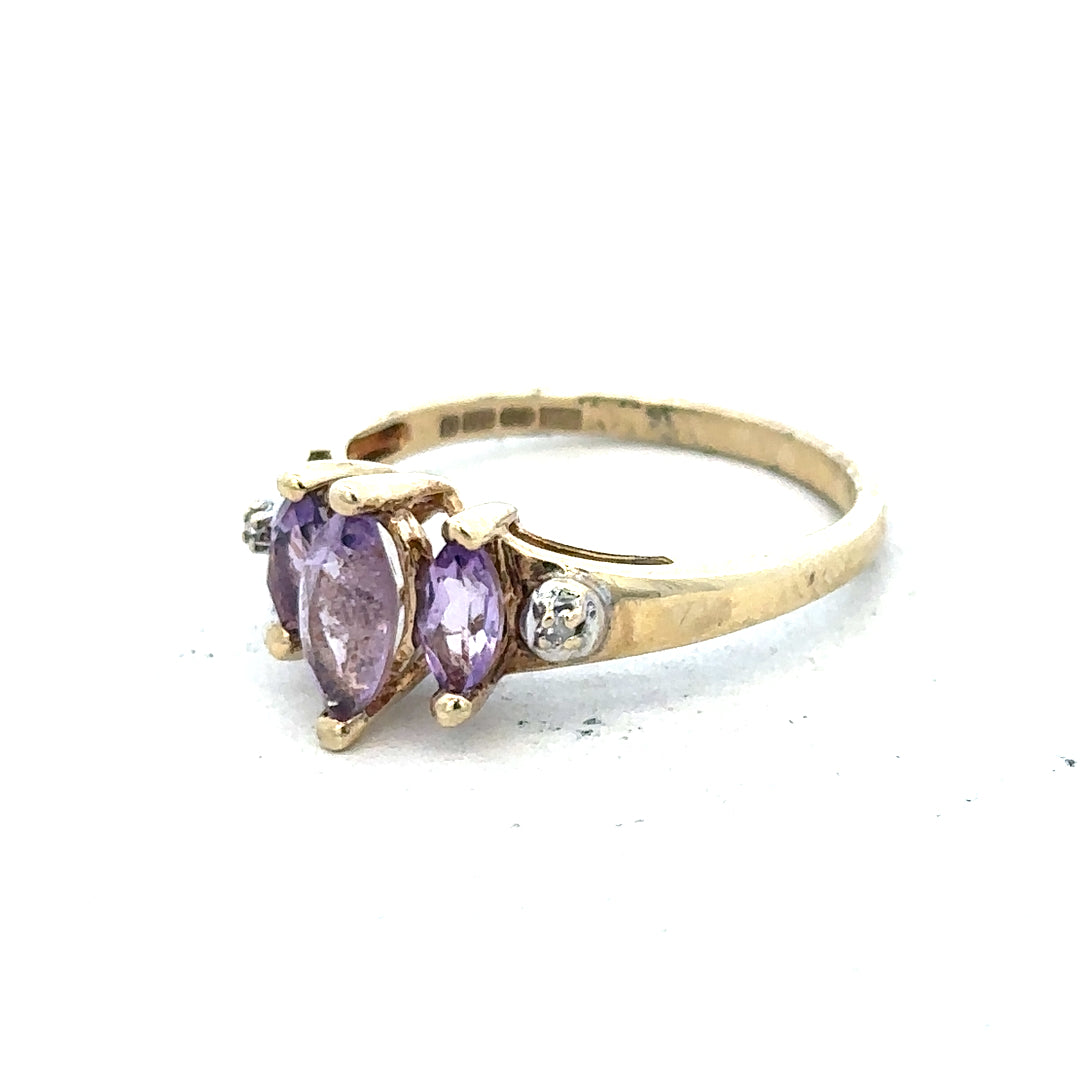 9ct yellow gold amethyst and diamond ring showcasing a purple gemstone surrounded by small diamonds, size P.