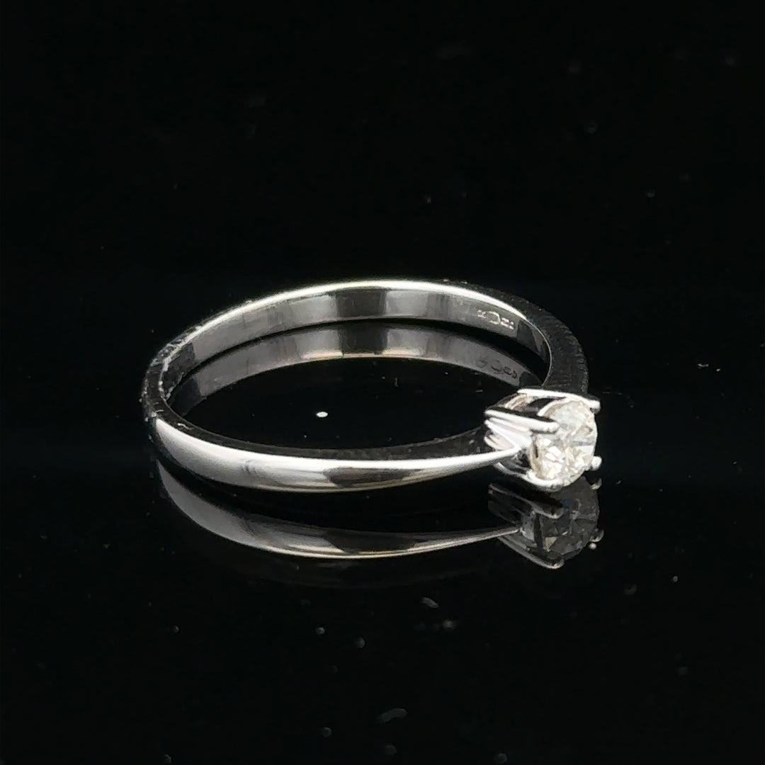 18ct white gold diamond ring with 1/4 carat diamond, size P1/2, featuring a sleek, elegant design.