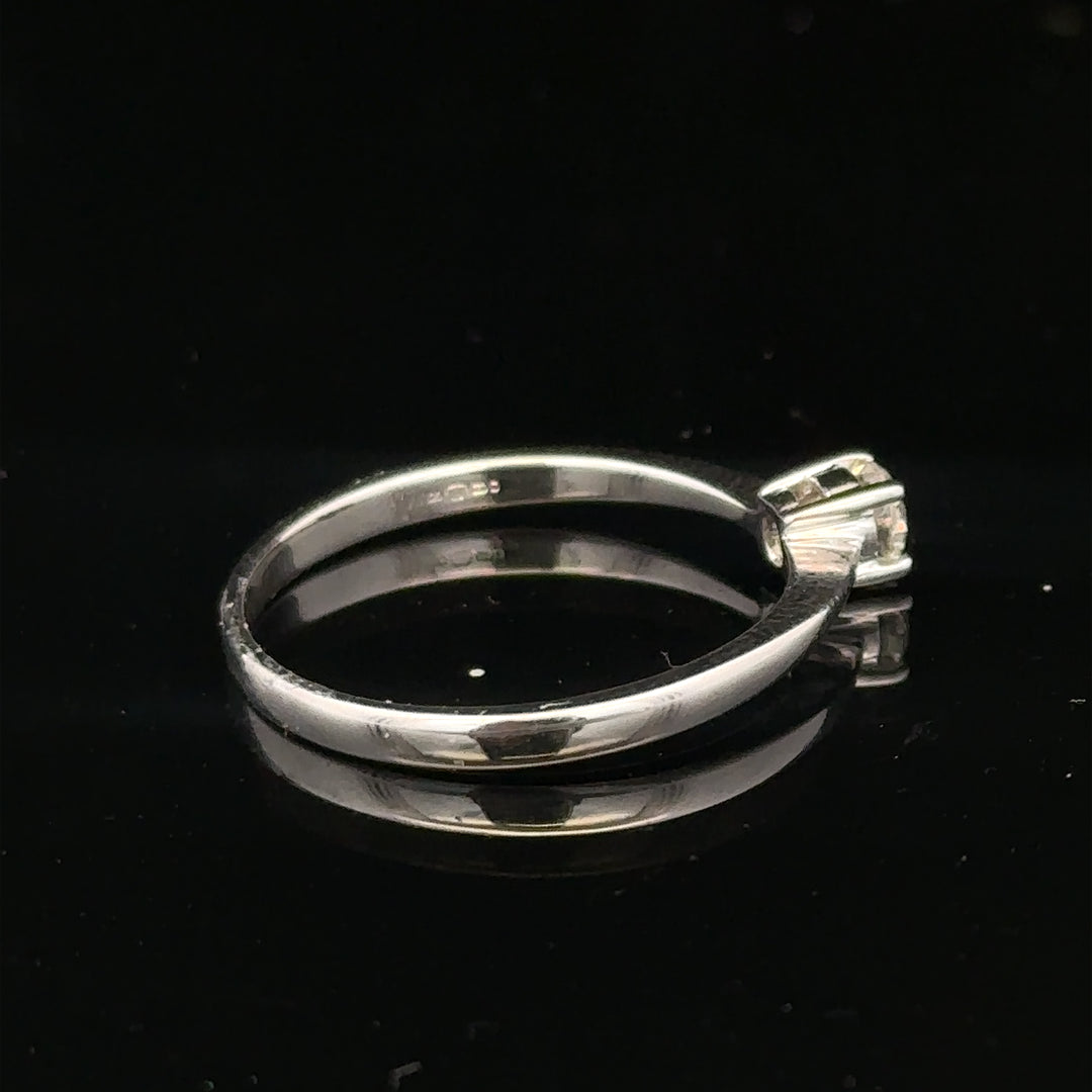18ct white gold diamond ring with 1/4 carat diamond, size P1/2, featuring a sleek and elegant design.