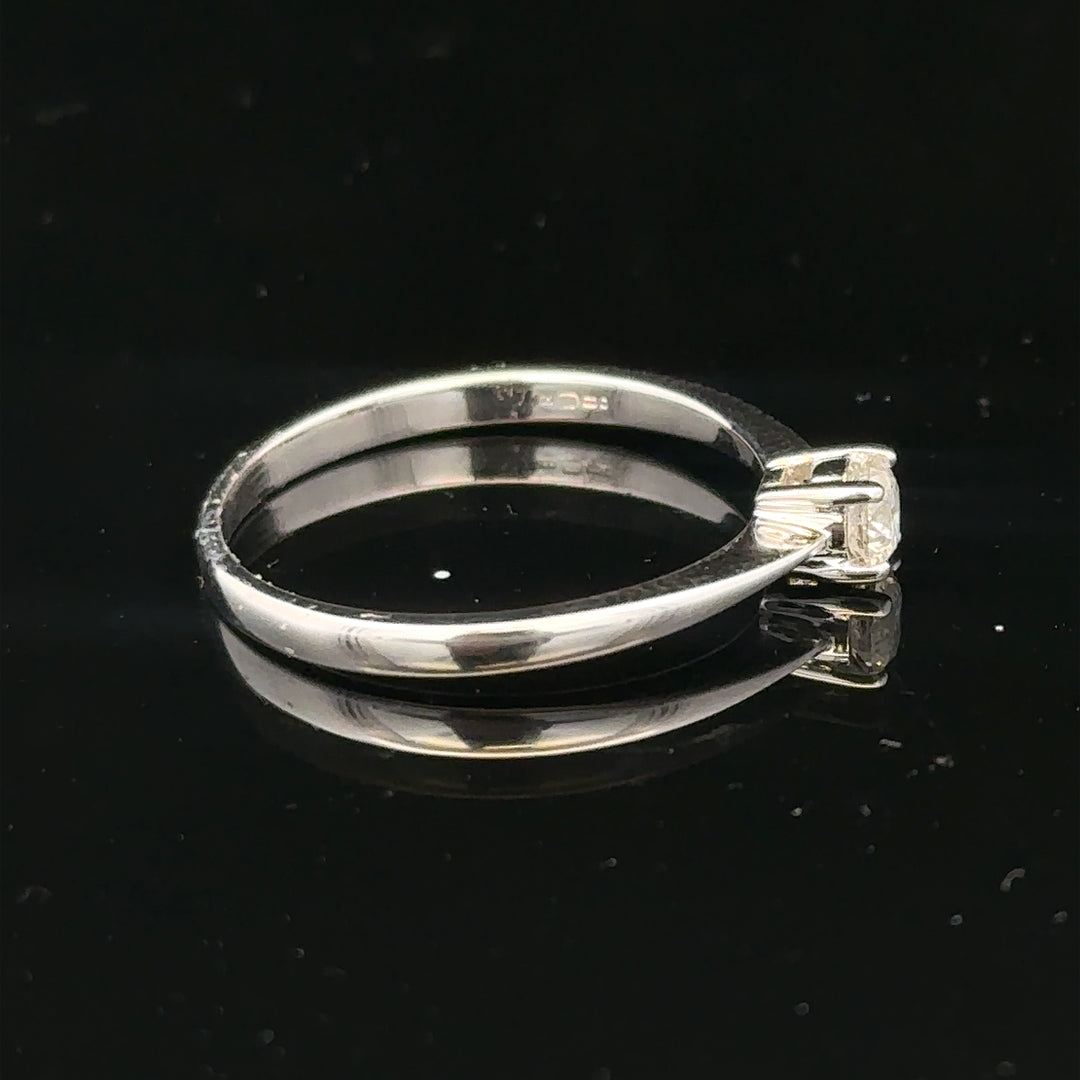 18ct white gold diamond ring with 1/4 carat diamond, size P1/2, featuring a sleek and elegant design.