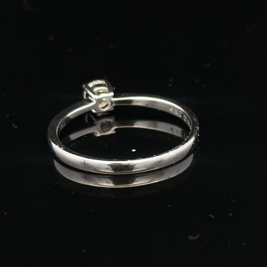 18ct white gold diamond ring with 1/4 caret center stone, size P1/2, featuring a sleek, elegant design.