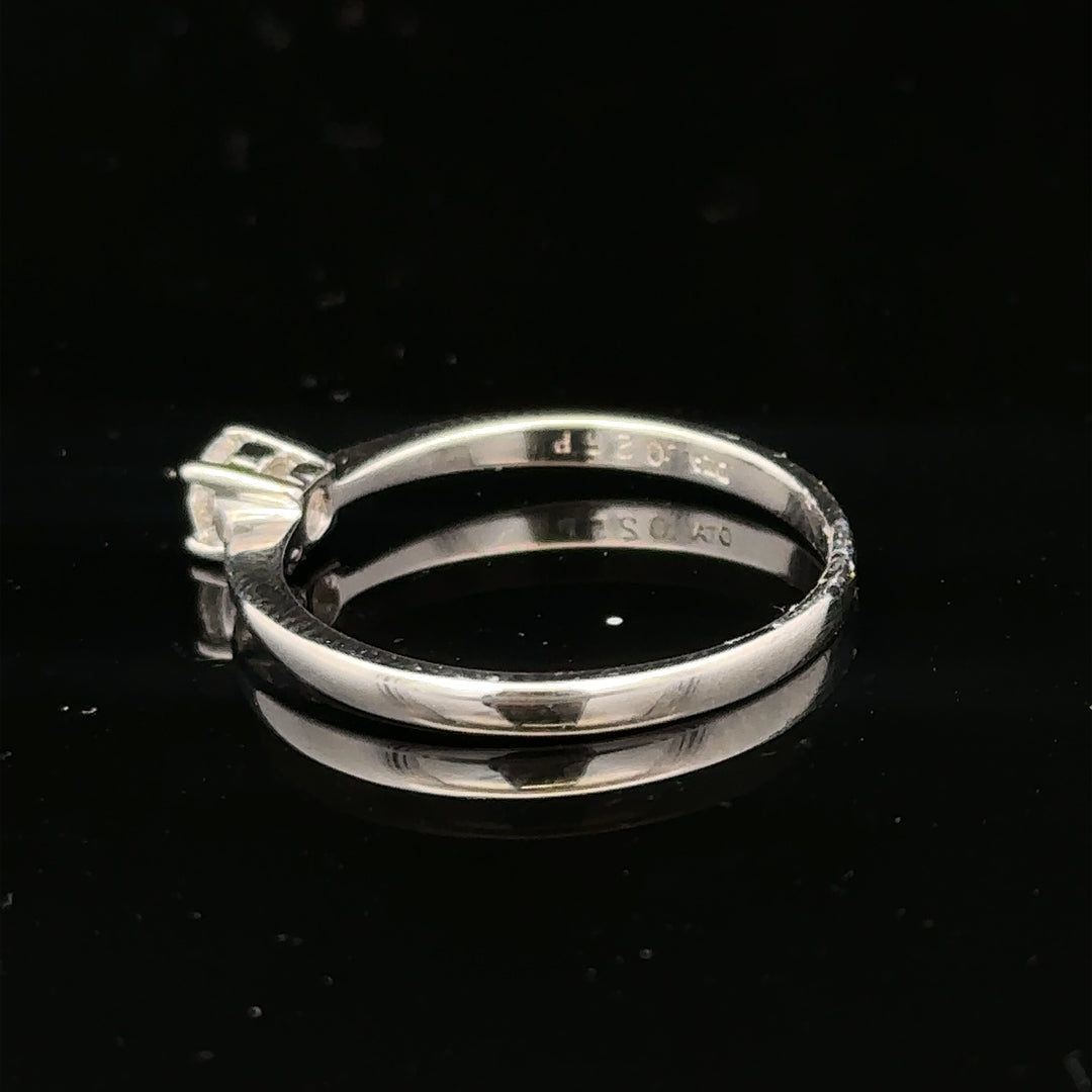 18ct white gold diamond ring with 1/4 carat solitaire, size P1/2, featuring a sparkling diamond on a sleek band.