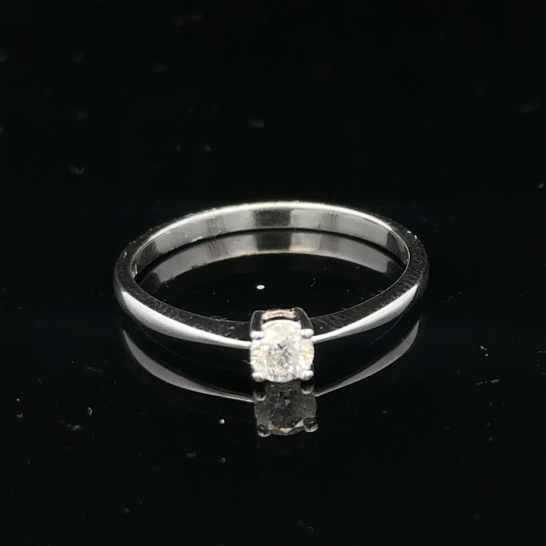 18ct white gold diamond ring with 1/4 carat center stone, size P 1/2, featuring a sleek and elegant design.