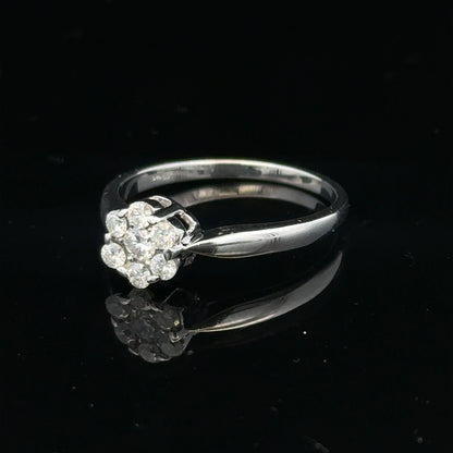 9ct white gold diamond cluster ring size O 1/2 with multiple sparkling diamonds on a plain background