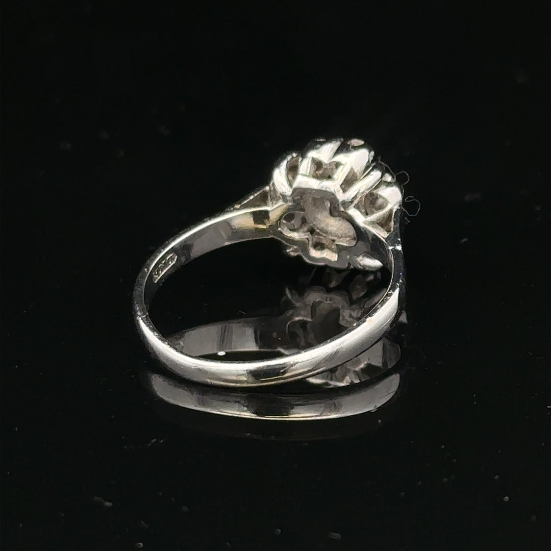 9ct white gold cluster diamond ring by Reeves and Sons featuring a sparkling diamond cluster design.